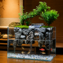 Desktop moss running water aquascape terrarium with live plants, resin rockwork, and a miniature waterfall for small fish.