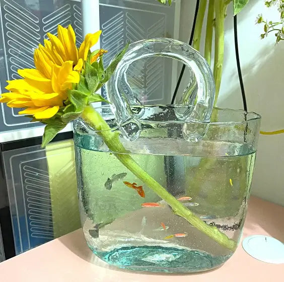 Handbag Fish Tank shown being carried, demonstrating its portable handbag-style design